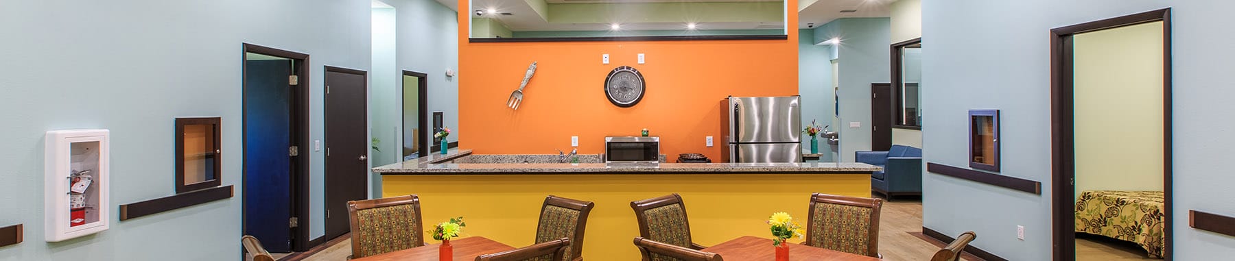 Bright common area with kitchen and dining setup