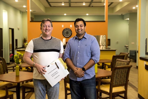 Residents engaging in a common area with staff