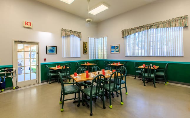 Bright dining room with tables set for meals