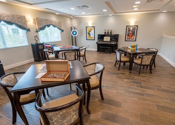 Common area with piano and tables for activities