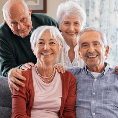 Smiling seniors posing together in a cozy living room