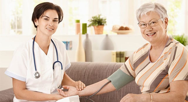 A nurse taking a resident's blood pressure