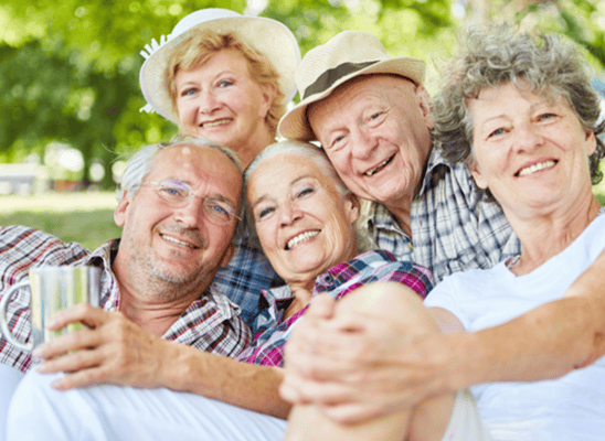 Seniors enjoying time together in a sunny outdoor setting