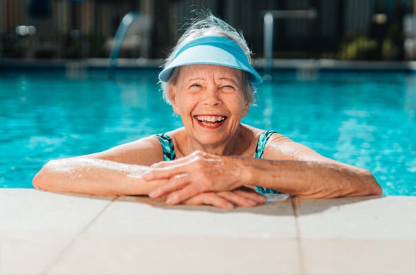 A happy senior woman enjoying the pool