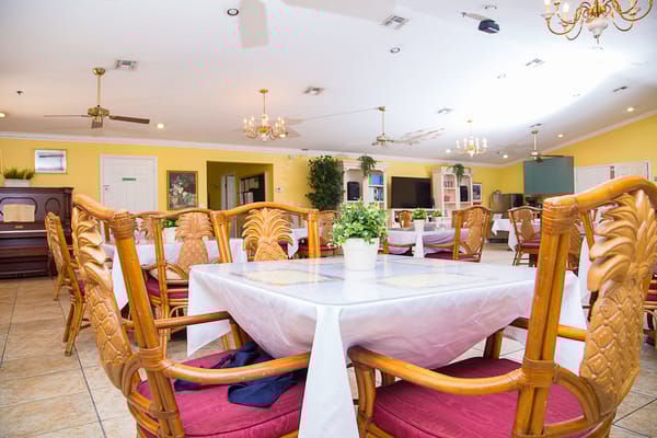 Bright dining room with wooden chairs and tables