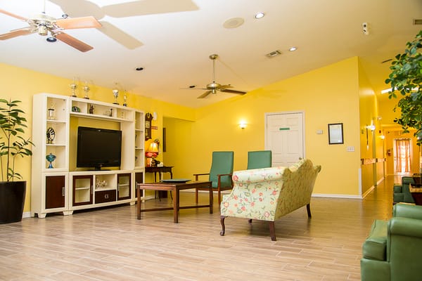 Common area with seating and decor in a senior living facility