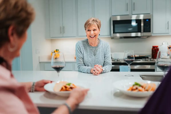 Residents enjoying a meal together in the facility kitchen