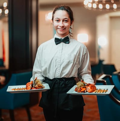 Staff member serving food in the dining area