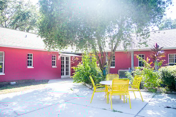 Outdoor seating area with yellow chairs and a table