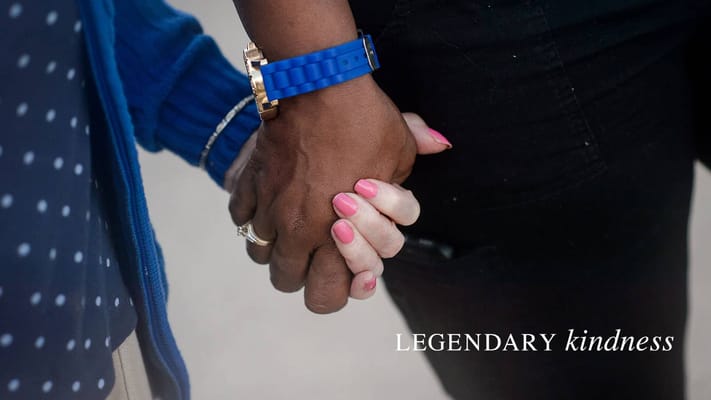 Two hands clasped together, symbolizing kindness