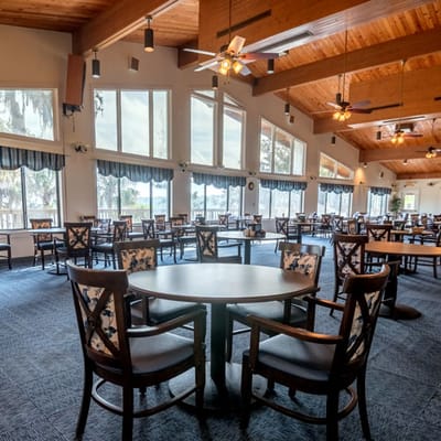 Indoor dining area with large windows and wooden beams