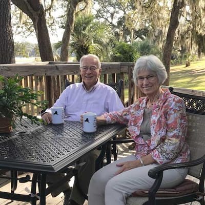Two residents enjoying coffee on a balcony