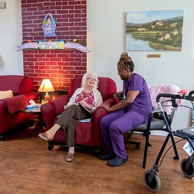 Resident enjoying time with staff in a common area