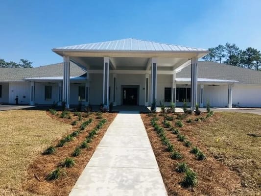 Building exterior of Navarre Gardens with landscaped entry