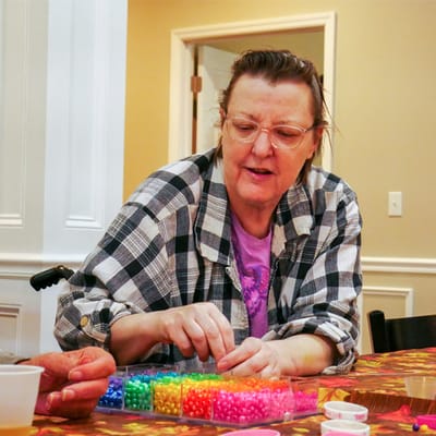 Resident engaged in a colorful activity at a table