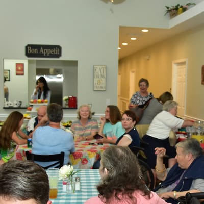 Residents enjoying a meal in a bright dining area