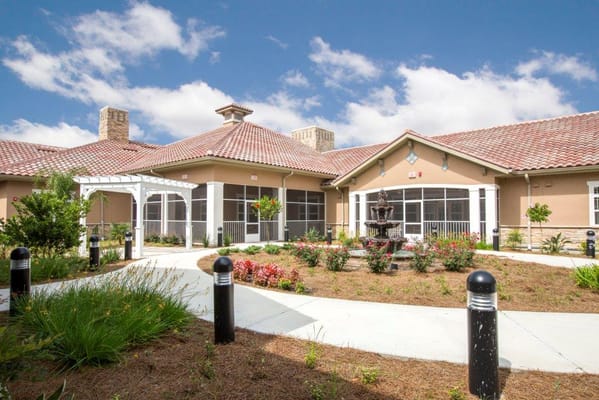 Exterior view of the assisted living facility's entrance and garden