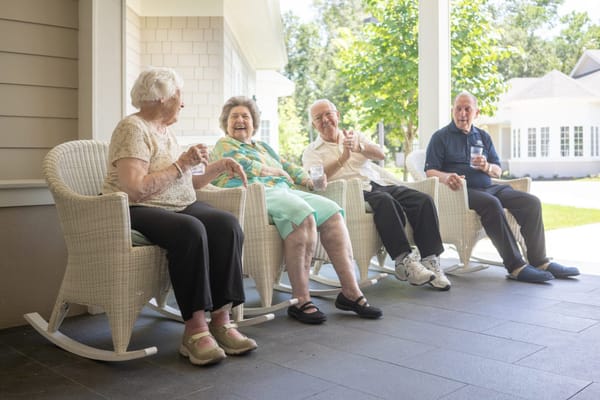Residents enjoying drinks on a porch in warm weather