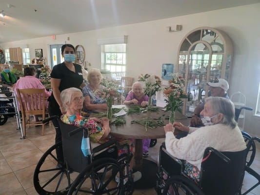 Residents participating in a flower arranging activity