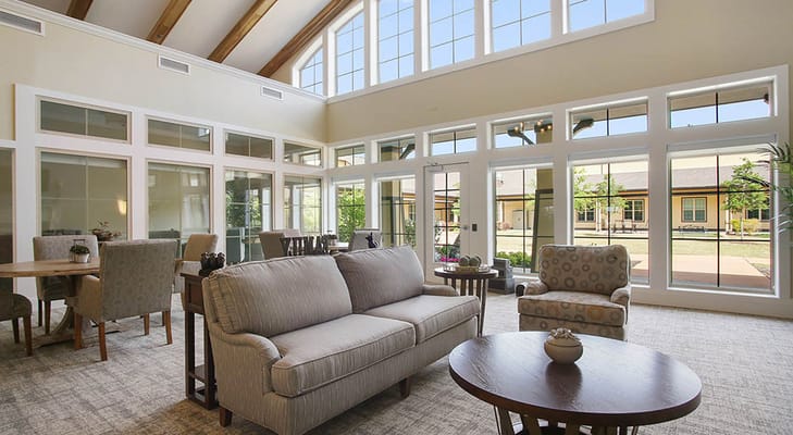 Bright common area with seating and large windows