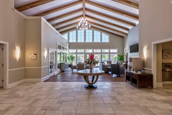 Bright common area with high ceilings and plants