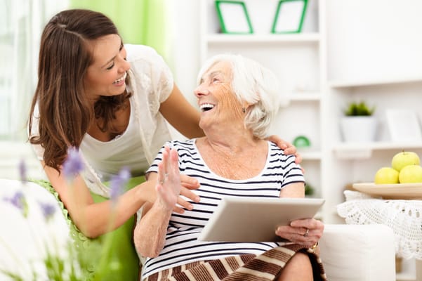 A staff member engaged with a smiling resident
