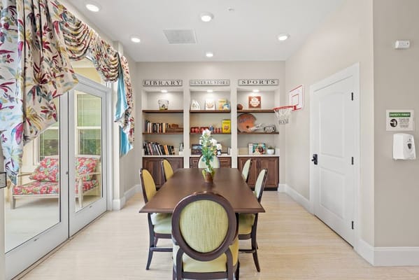 Common area with a dining table and bookshelves