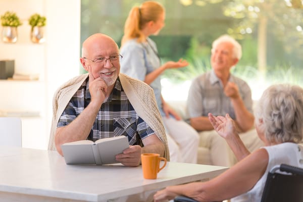 Residents engaging in a light-hearted conversation indoors