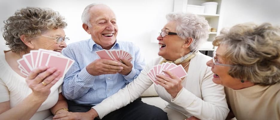 Residents enjoying a game of cards in a common area