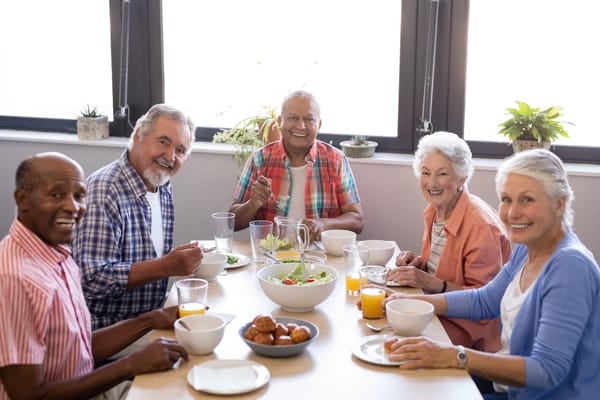 Residents enjoying a meal together in a dining room