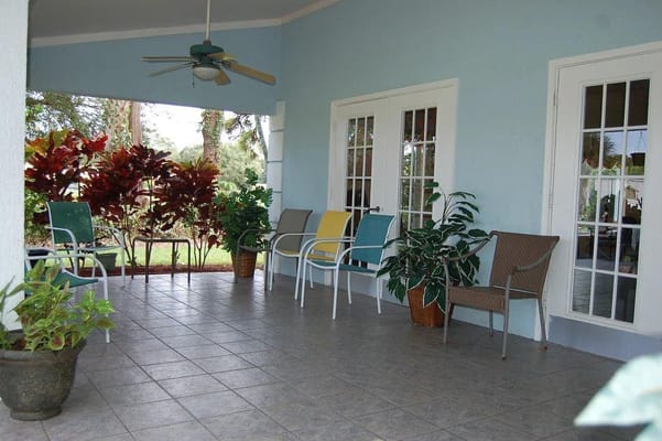 Outdoor seating area with colorful chairs and plants