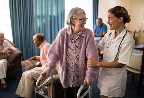 Staff assisting a resident in a common area