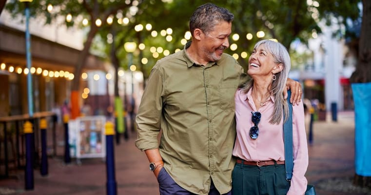 A couple enjoying a walk in a beautifully lit outdoor space