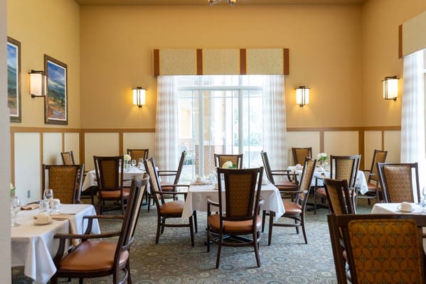 Elegant dining room setup with tables and chairs