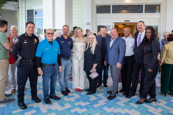 Group of people celebrating outside the facility entrance