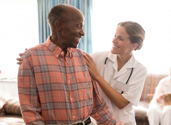 Staff member assisting a resident in a warm setting