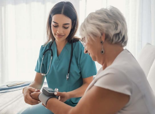 Caregiver taking blood pressure of a senior resident