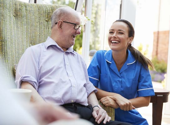 Caregiver interacting with a resident in a bright common area