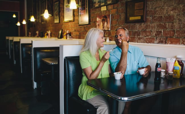 Couple enjoying dessert in a cozy dining area