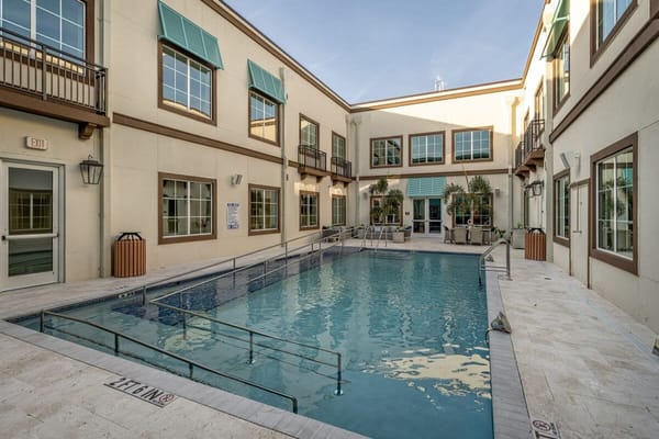 Outdoor pool area surrounded by the building exterior