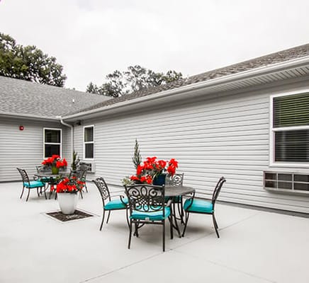Outdoor patio area with seating and flowers