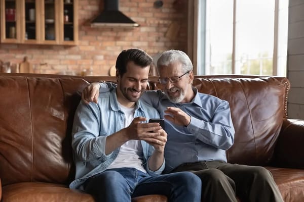 A resident and visitor enjoying time together on a couch