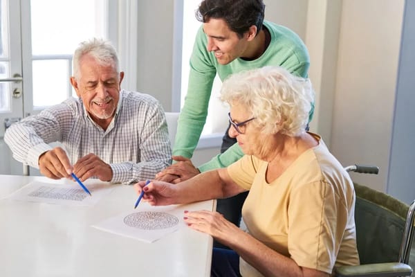 Residents engaging in a creative activity at a table
