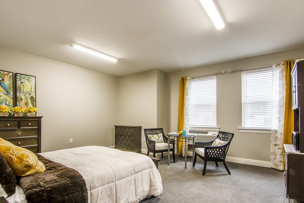 A well-furnished private resident room with natural light