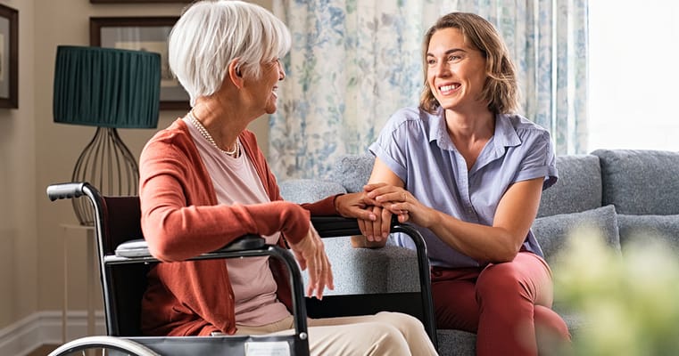 A caregiver and a resident sharing a warm conversation