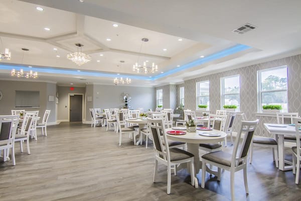 Bright dining room with white tables and chairs