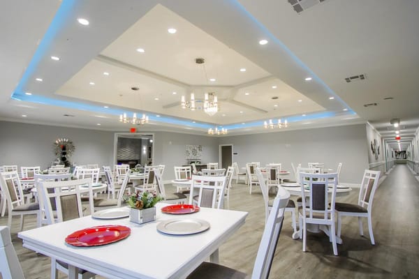 Bright dining room with tables and chairs set up for meals