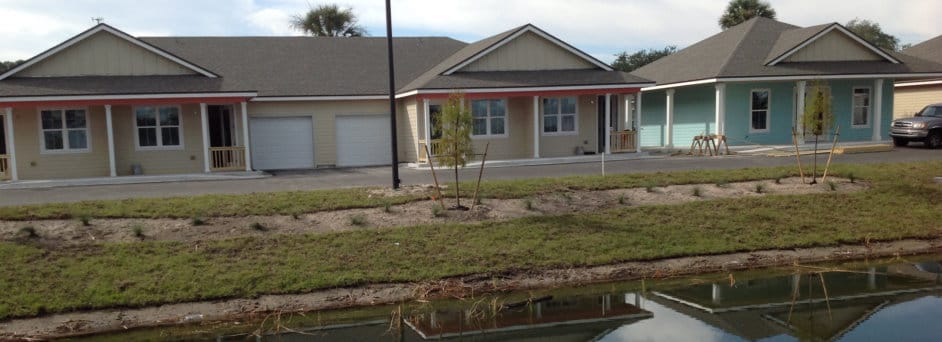 Exterior view of assisted living cottages by a pond