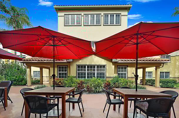 Outdoor seating area with umbrellas and building in background