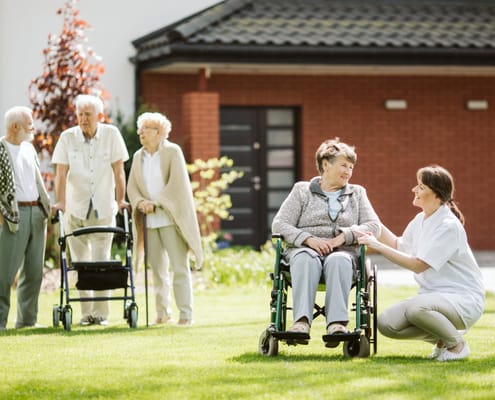 Residents enjoying time outdoors with a staff member